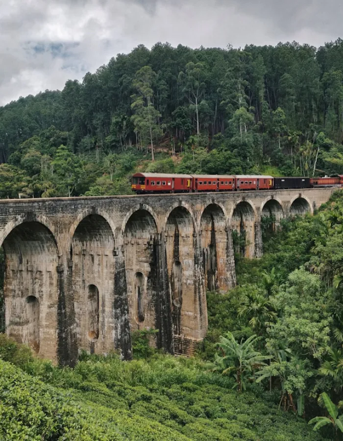 Nine Arch Bridge surrounded by lush hills in Ella